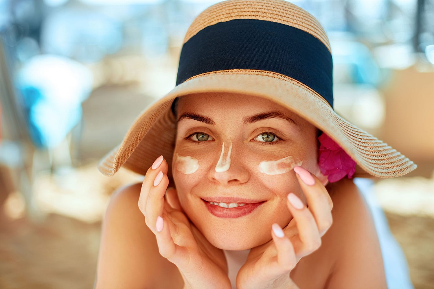 Soothing sunburn, Young pretty woman applying sun cream and touch own face.