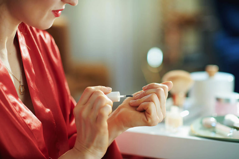 OPI Nail Polish. Woman applying nail polish.