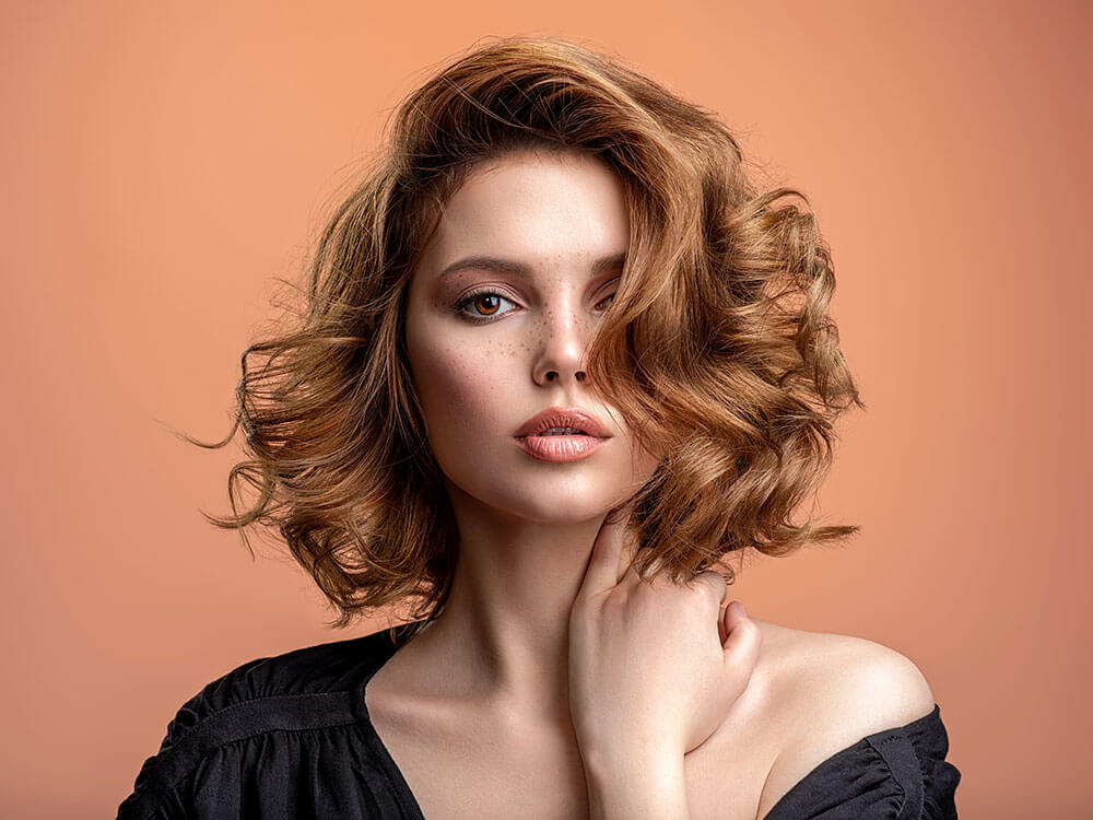 Beautiful young woman with red curly hair