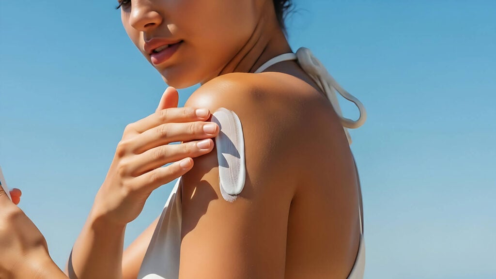 Beauty Blog Woman applying mineral sunscreen for oily acne-prone skin on sunny day