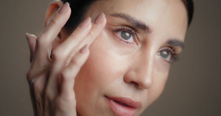 Mature woman touch and skincare in studio closeup and perspective