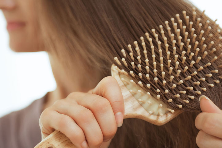 Beauty Blog Closeup on young woman combing hair stock photo