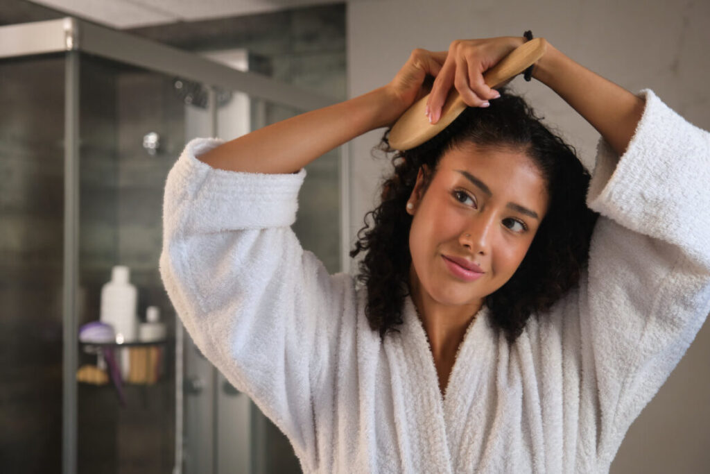 Beauty Blog woman in a robe combing her hair