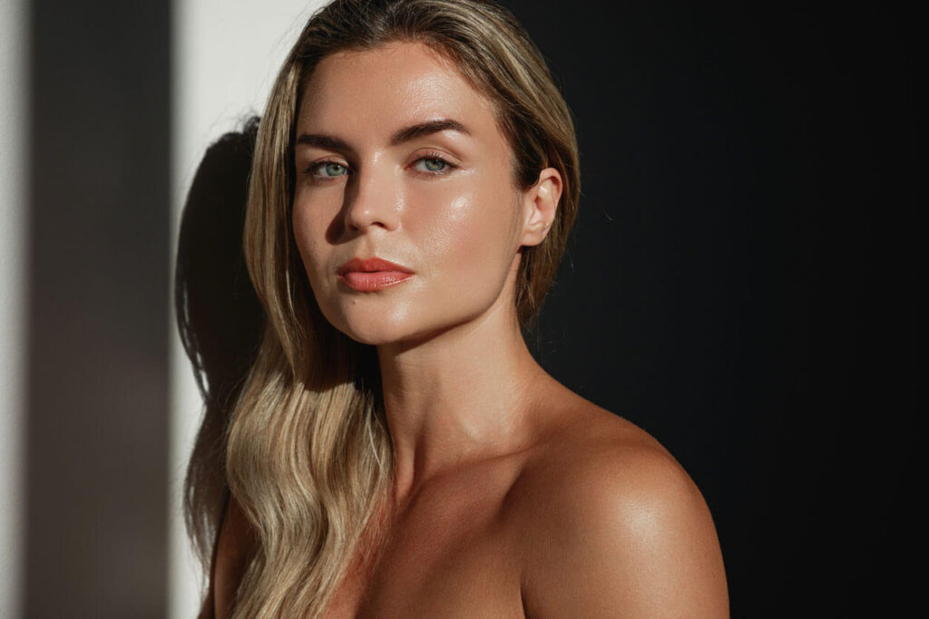 Beauty Blog Portrait of young woman with long blonde hair in sunlight