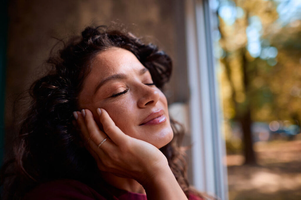 Beauty Blog Serene woman enjoying a peaceful moment with closed eyes