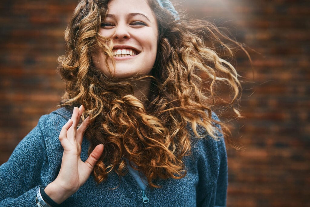 Beauty Blog Beautiful girl with windblown hair laughs