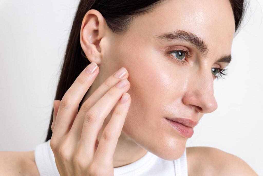 Beauty Blog Young woman showcasing her skincare routine for healthy, glowing skin stock photo