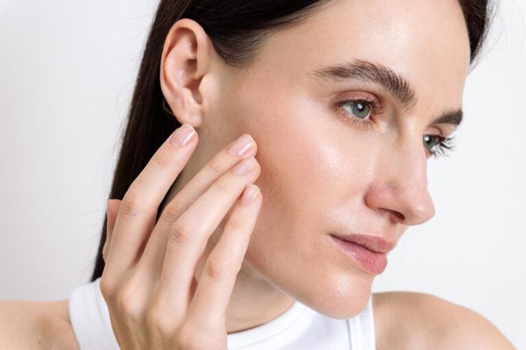 Young woman showcasing her skincare routine for healthy, glowing skin stock photo