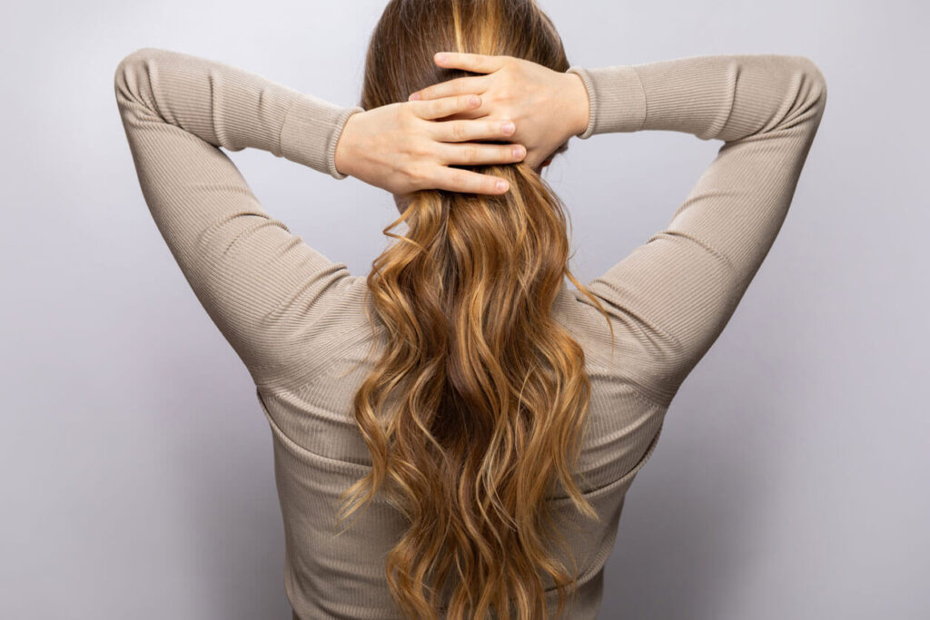 Hair Care Young woman showing her beautiful hair
