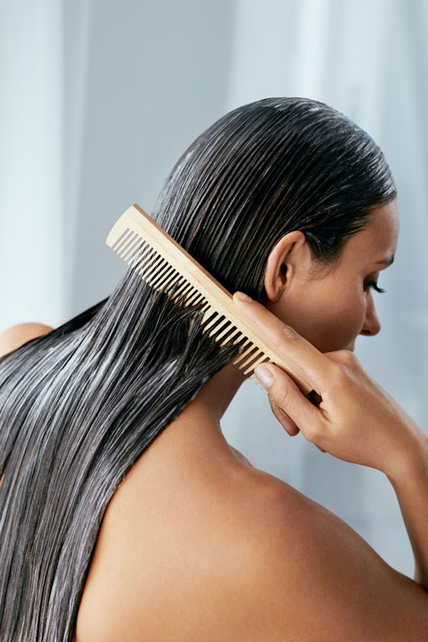 Beauty Blog Hair Treatment. Woman With Mask On Wet Hair Closeup stock photo