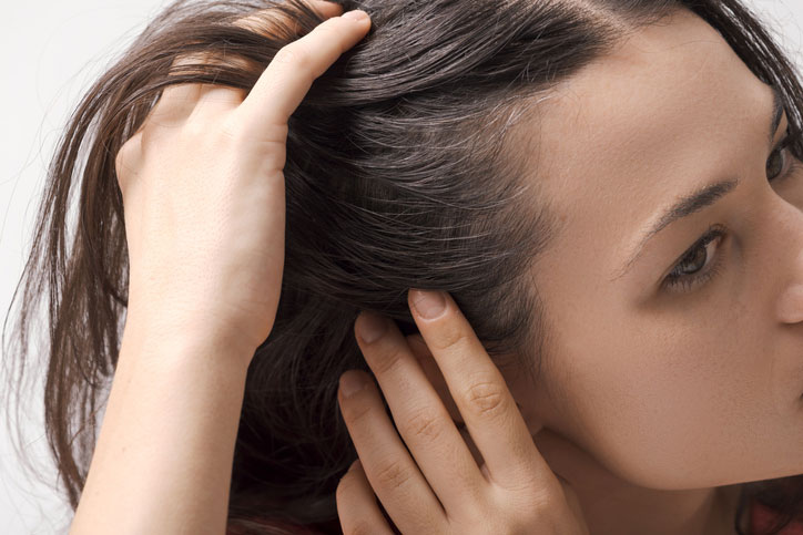 Beauty Blog Young woman checking her hair for scalp buildup