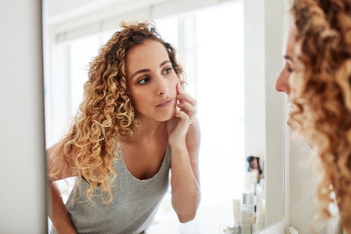 Are you happy with the woman staring back at you? stock photo